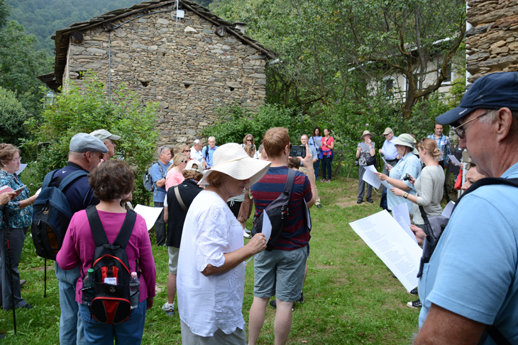 Group singing in front of Ancestral home